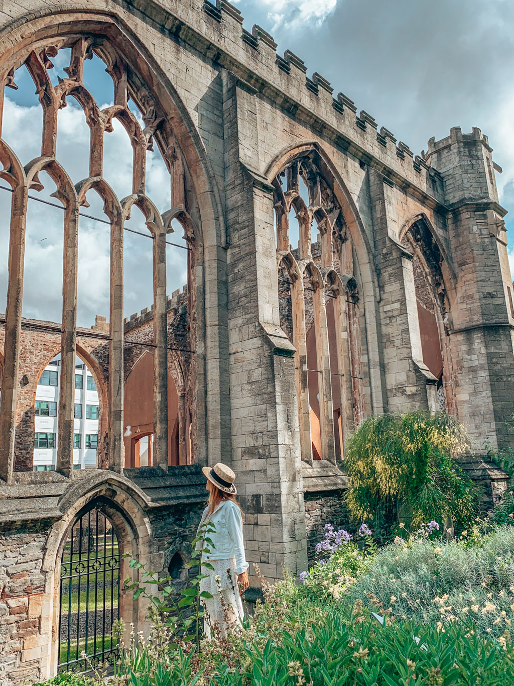 Girl looking at a Church in ruins